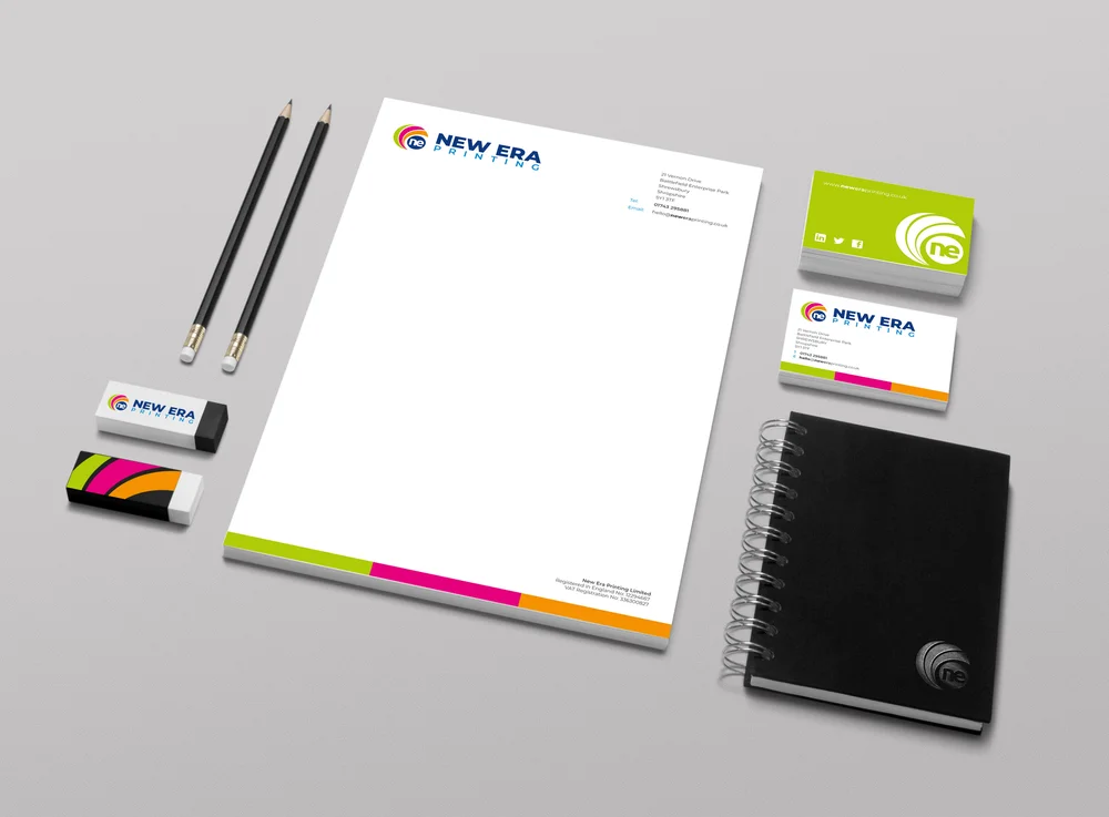 Branded stationery set from New Era Printing, including pencils, erasers, a letterhead, business cards, and a spiral-bound notebook.